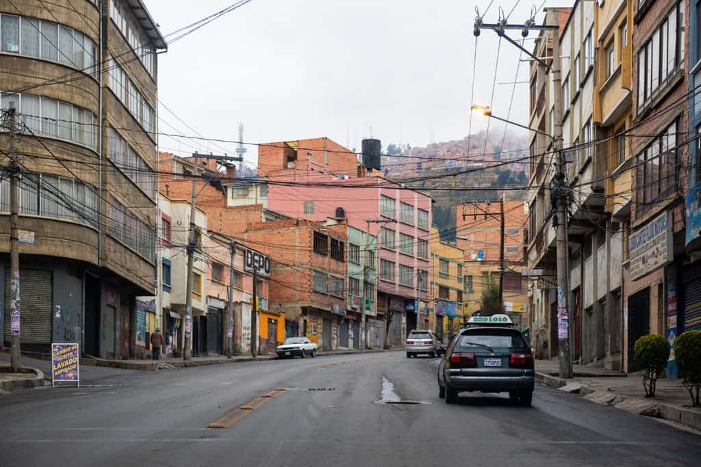 Street scene with cars and buildings in a neighborhood in La Paz, Bolivia