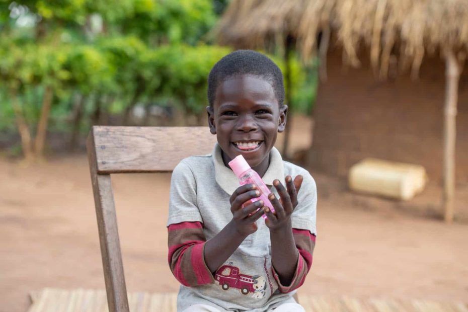 young boy with a huge smile sitting