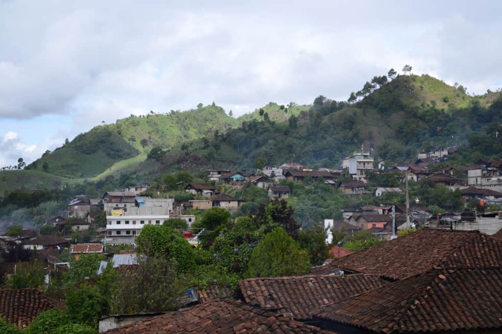 View of rolling hills with green trees and forest in the region of the Highlands showing the village of Chajul, Quiche.