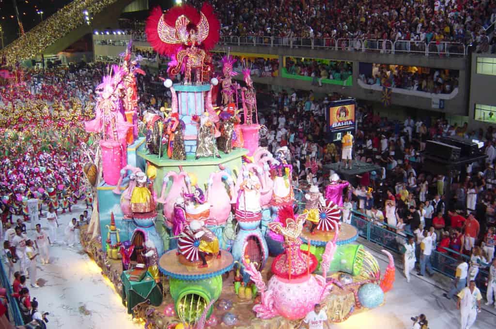 Colorful parade float surrounded by a large crowd of spectators.