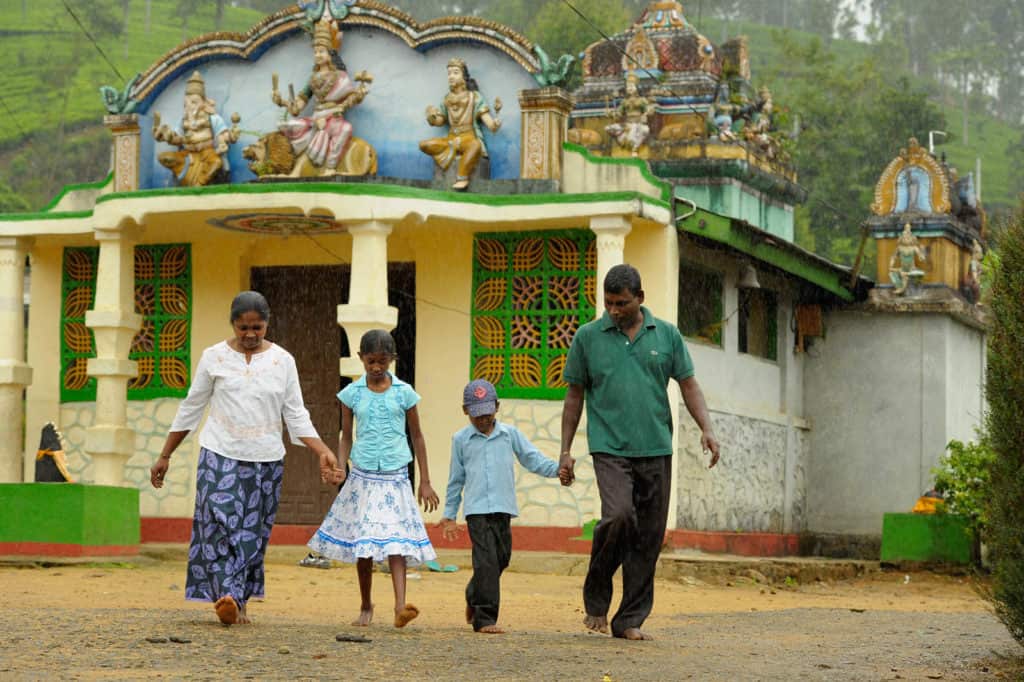 Jaya Praveen and his dad, M Marimutthu, his mom Rajeshwari, and his sister, M Karthika walking in the rain.