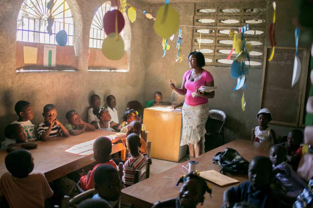 A teacher teaching on a project day at HA862. Decorations hang from the ceiling of the classroom.