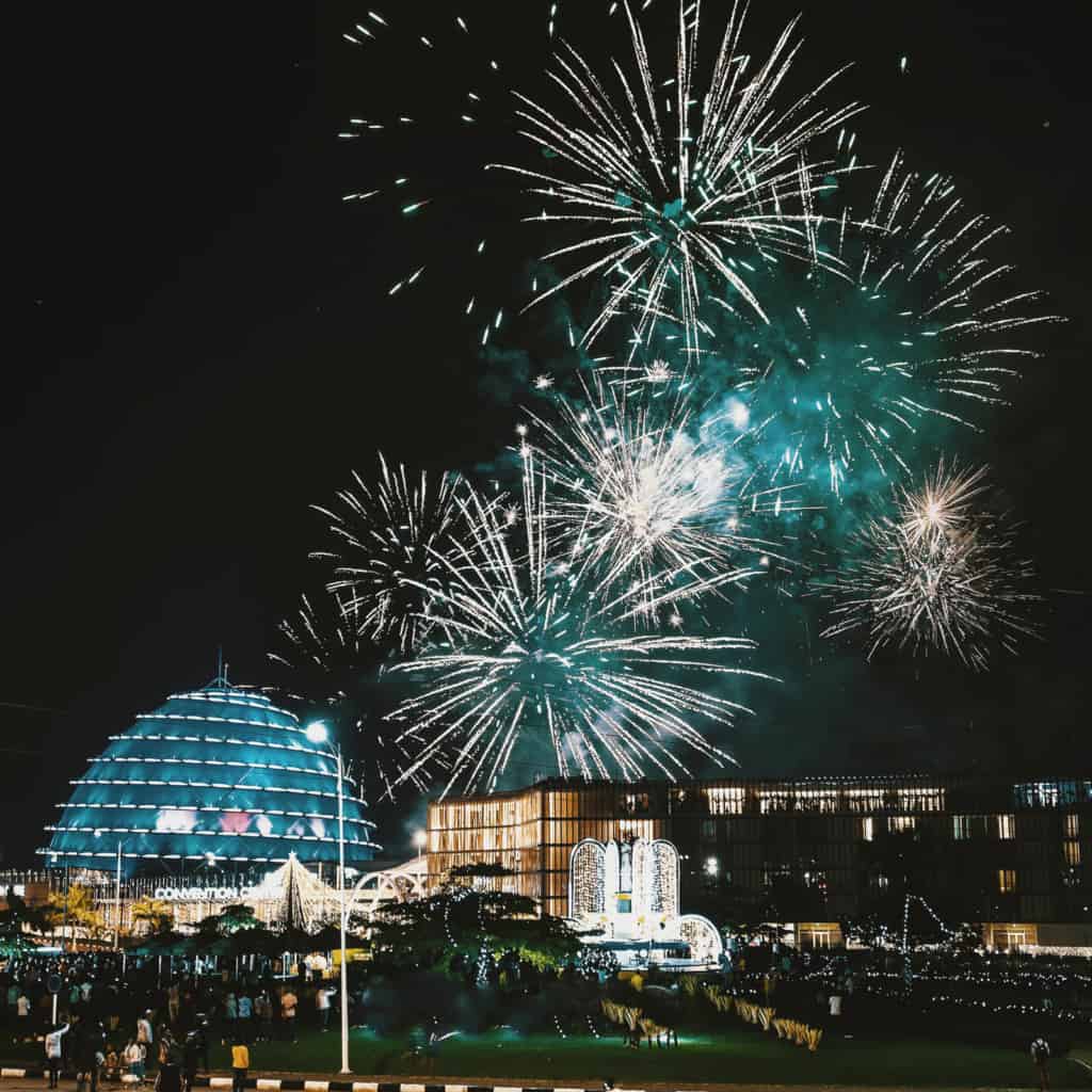 Fireworks exploding in the sky above a city.