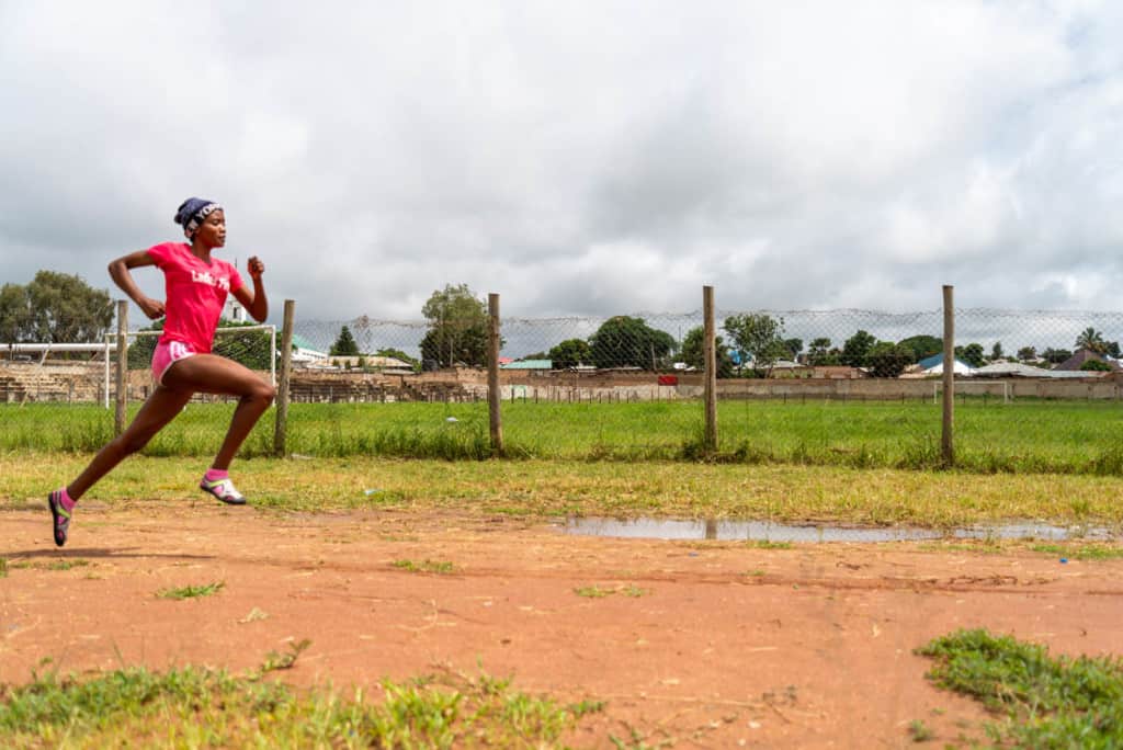 Girl running on a dirt track