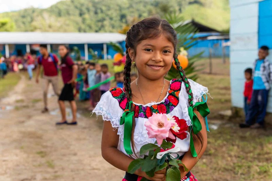 A smiling girl in traditional Mexican clothing