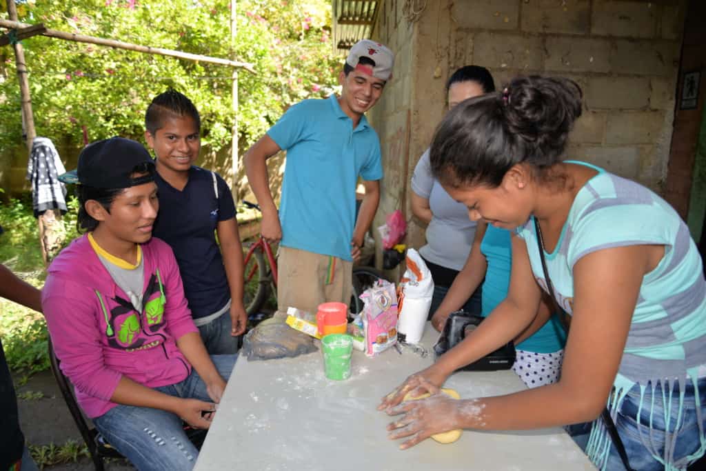 A Compassion center tutor visits the home of Junior, a teen in the program. Junior's family is making a meal