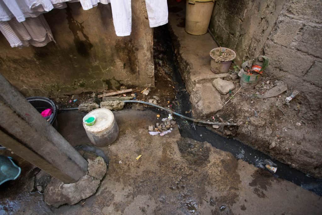 Plastic water pipes snake their way into their community, through the dirt and open sewers. Most of the public faucets are not sanitary, which is why families boil the water to make it safe for drinking or buy bottled water for drinking.