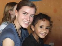 A woman and the child she sponsors through Compassion smile.