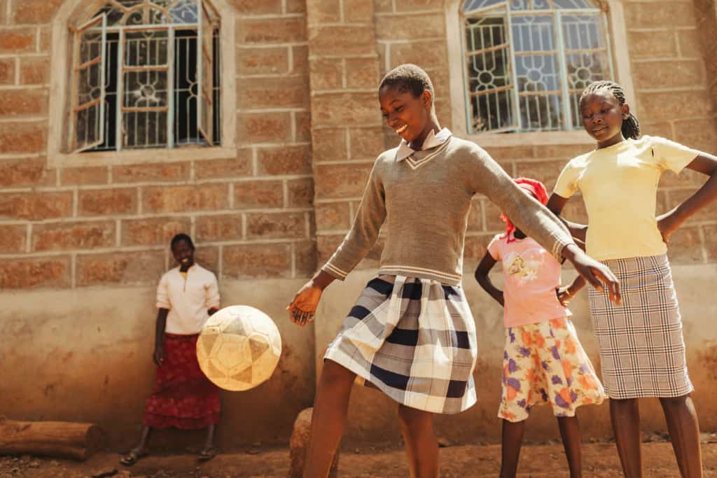 Four girls playing soccer