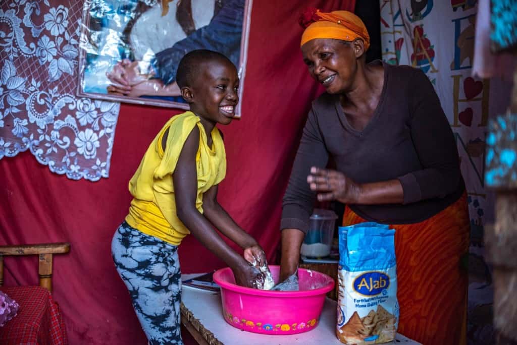 Leach and her grandmother are seen here laughing and smiling and making Chapati, or Indian flatbread.