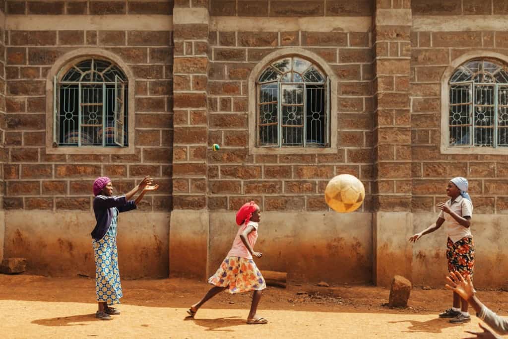 Group portraits and shots of teen girls playing outside project in Solai, Kenya