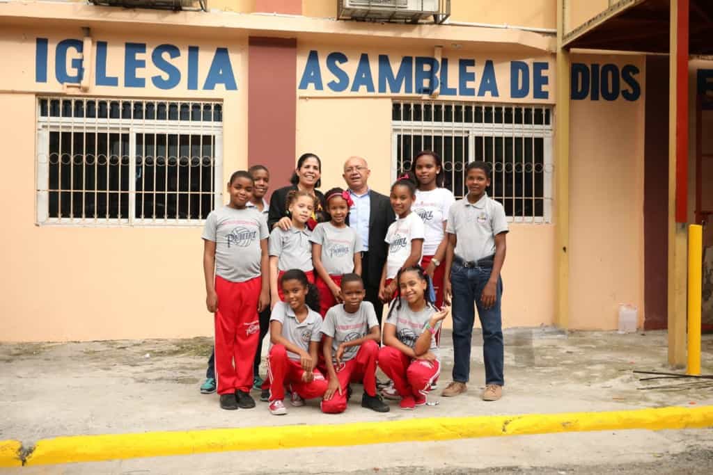 Some of the children and staff pause for a photo in front of the church that hosts your child's Compassion center.