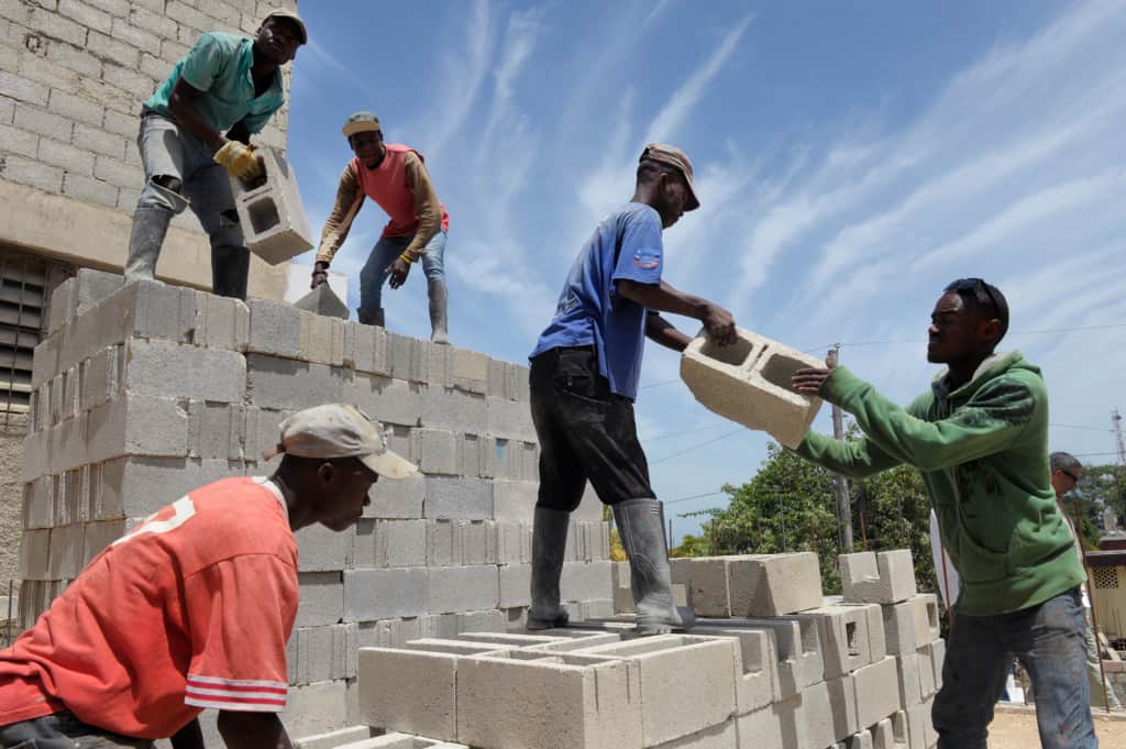 Haitian workers rebuild a school that was destroyed in the 2010 earthquake