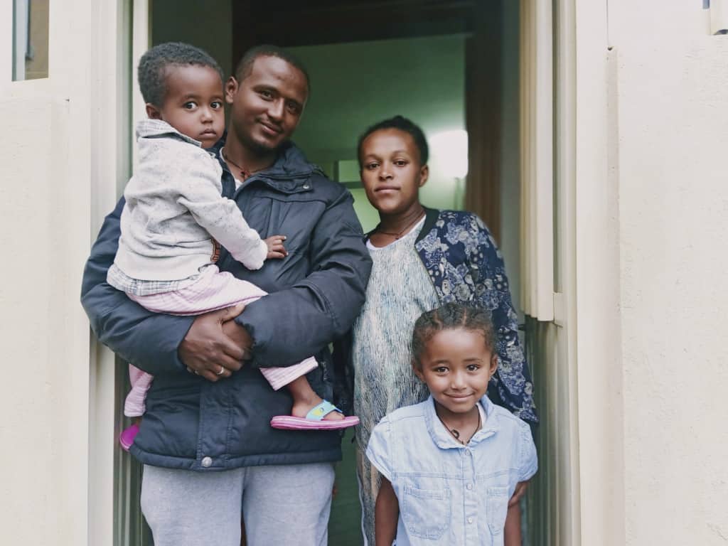 Sintayehu with his wife and their two children at home in Ethiopia