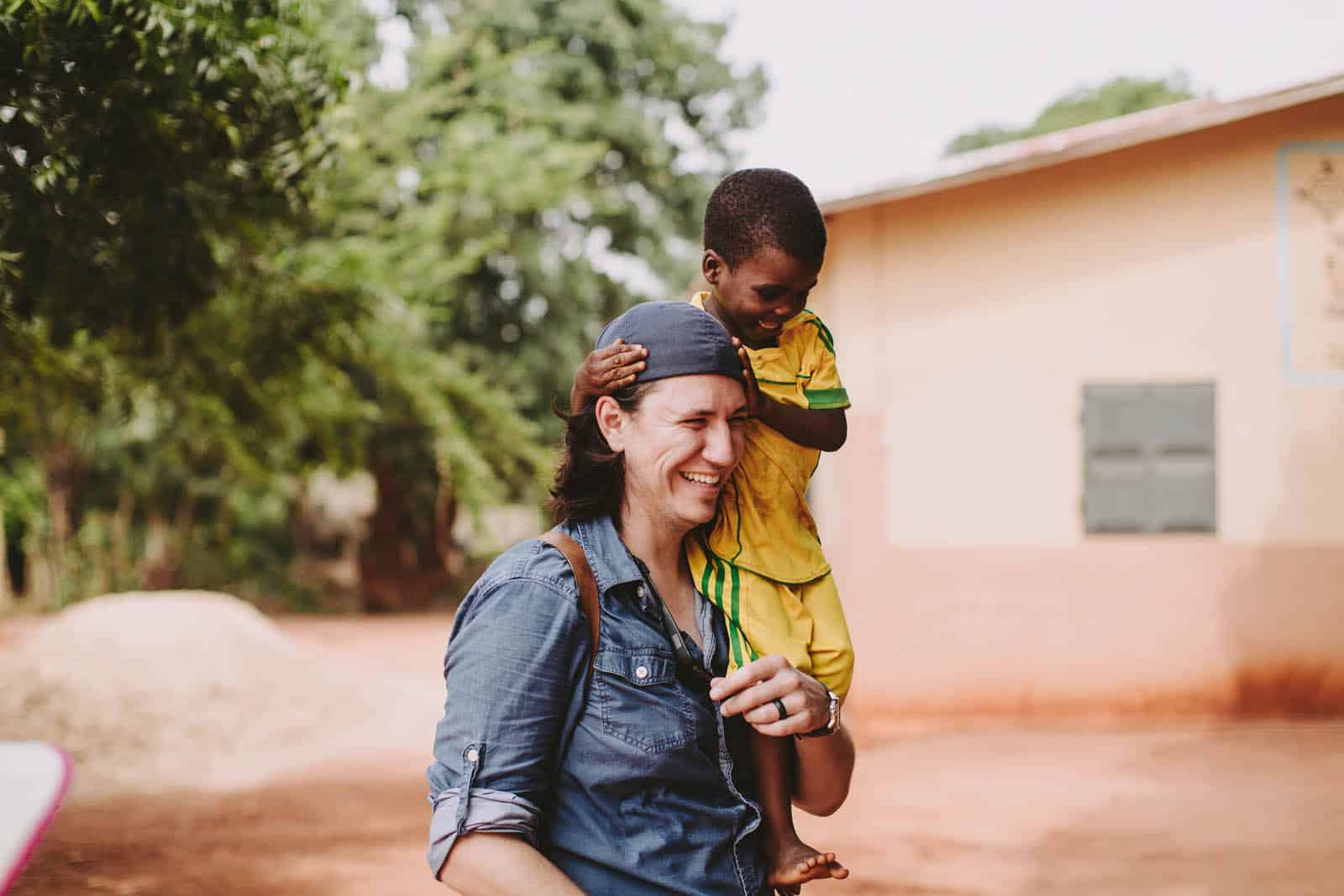 Man carrying a young boy on his shoulders