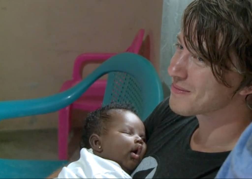 Mike Donehey holds a baby in Compassion’s Survival Program on a 2012 trip to Honduras