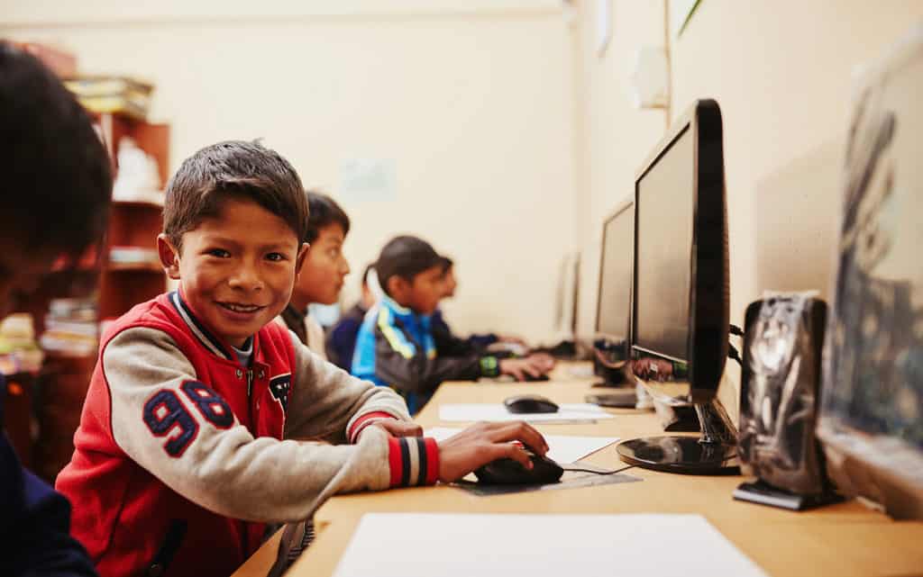 A boy in Bolivia uses a computer in a lab at his Compassion center. Compassion's latest charity streaming event will help build similar computer labs in Bolivia.