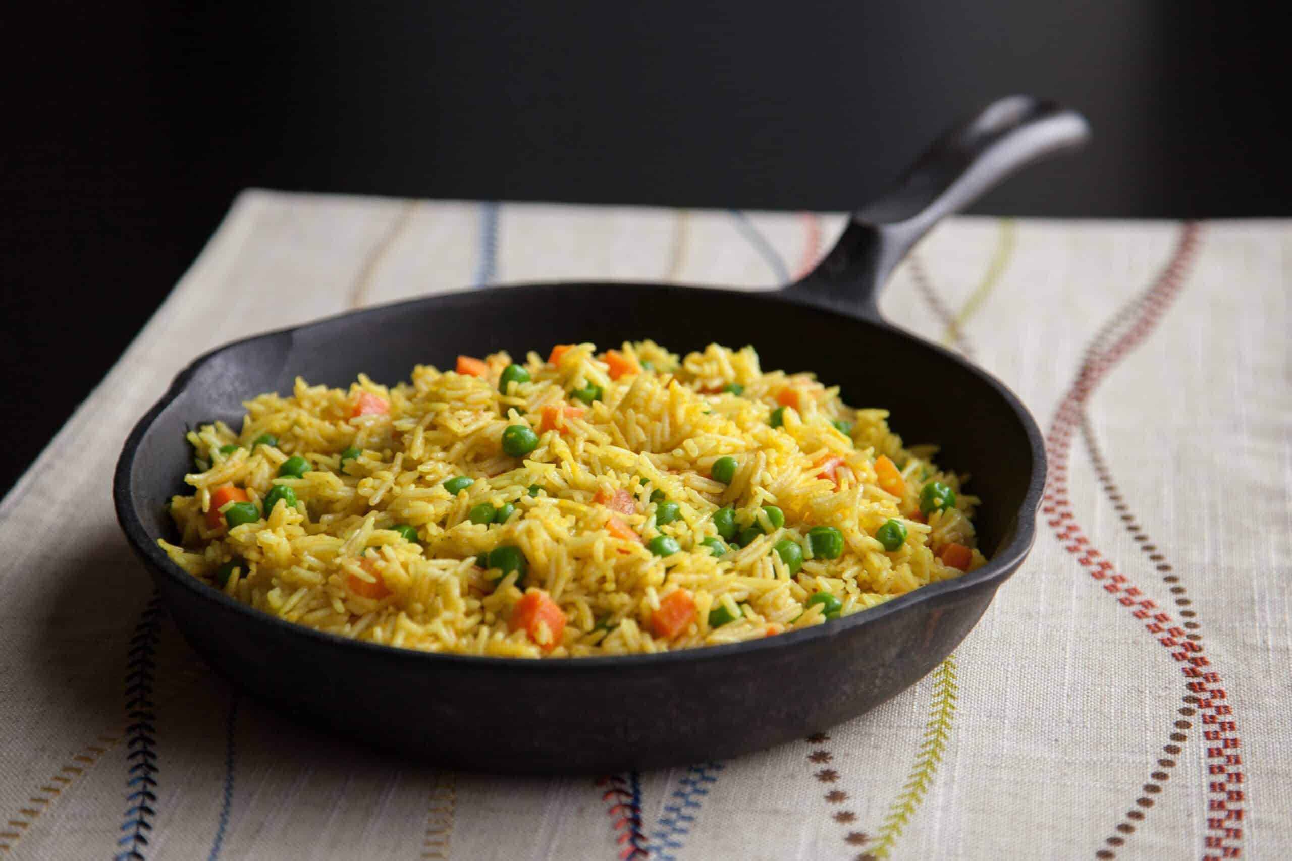 Tanzanian coconut rice sitting in a cast iron pan.