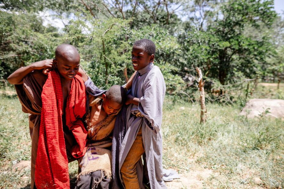 CC-TZ0146-GoodSamaritan-14-2502 Two African boys help another African boy up off the ground.